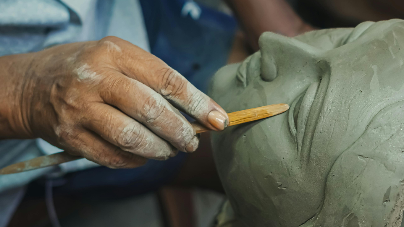 Artisan sculpting clay